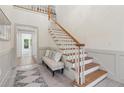 Bright foyer featuring staircase with oak handrail and bench seating at 979 Bridgegate Ne Dr, Marietta, GA 30068