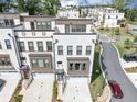 View of modern townhomes, with attached one car garages, and manicured lawns at 2171 Burnside Dr Nw, Atlanta, GA 30318