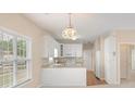 Eat-in kitchen with white cabinets, countertop and bright natural light at 310 Autumn Glen Cir, Fayetteville, GA 30215