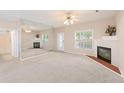 Bright living room with a fireplace, large mirror, and ample natural light at 310 Autumn Glen Cir, Fayetteville, GA 30215