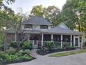 Beautiful exterior view showcasing the home's architecture, a screened in porch, and lush landscaping at 3978 Devonshire Dr, Marietta, GA 30066