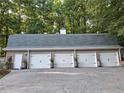 Large four-car garage offers ample parking and storage, with neutral doors and brick facade at 3978 Devonshire Dr, Marietta, GA 30066