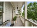 Cozy covered porch with a bench, potted plants, and a ceiling fan for relaxed outdoor living at 1165 Victoria Ne St, Brookhaven, GA 30319