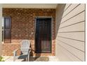 Welcoming front entrance featuring a black metal security door and decorative brick accents at 2267 Clapton Ct, Jonesboro, GA 30236