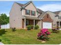 Attractive home with colorful flowers in the yard and well-maintained landscaping at 2267 Clapton Ct, Jonesboro, GA 30236