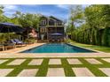 Beautiful backyard with a pool, patio, and lush landscaping, creating a private outdoor oasis at 2406 Glenwood Ne Dr, Atlanta, GA 30305