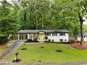 Charming ranch-style home with a well-manicured front yard and a bright yellow front door at 4396 Greenleaf Cir, Atlanta, GA 30331