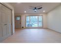Bright living room featuring a large window with views of the lush yard and a modern ceiling fan at 4396 Greenleaf Cir, Atlanta, GA 30331