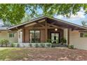 Close up of the front exterior with a covered porch with light wood accents and painted white brick at 5785 Timberlane Ter, Sandy Springs, GA 30328