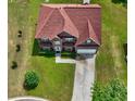 Aerial view of a two-story brick home with driveway and well-manicured lawn at 1506 Saint George Pl, Conyers, GA 30012