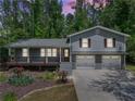 Inviting exterior view of the home with a welcoming front porch and a two-car garage at 4124 Dunnington Dr, Marietta, GA 30062