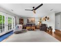 Inviting living room with hardwood floors, a modern ceiling fan, and comfortable seating at 5742 Harbor Dr, Buford, GA 30518