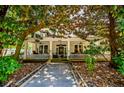 Charming two-story home featuring a classic front porch with white pillars, fans, and decorative railings at 8612 Campbellton St, Douglasville, GA 30134