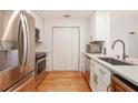 Galley kitchen with stainless steel appliances and hardwood floors at 1101 Juniper Ne St # 919, Atlanta, GA 30309