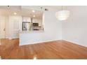 Open concept living room and kitchen with hardwood floors and modern lighting at 1101 Juniper Ne St # 919, Atlanta, GA 30309