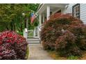 Beautiful landscaping of the property, with a variety of bushes and mature trees surrounding the home at 1161 Arborhill Dr, Woodstock, GA 30189