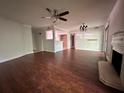 Living room with dark hardwood floors, ceiling fan, and view into the kitchen at 5400 Roswell Rd # L-3, Atlanta, GA 30342