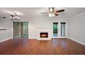 Cozy living room featuring a fireplace, hardwood floors, and sliding glass doors to the outside at 5400 Roswell Rd # L-3, Atlanta, GA 30342
