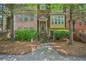 Charming townhome featuring a brick facade, well-maintained landscaping, and a welcoming front entrance at 62 High Top Pt, Sandy Springs, GA 30328