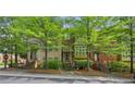 Attractive townhome with brick and siding, mature trees, and well-maintained front yard at 62 High Top Pt, Sandy Springs, GA 30328