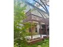 Multi-level back deck with green foliage surrounding the yard at 702 Emeril Dr, Avondale Estates, GA 30002