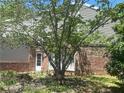 The backyard features mature trees, brick accents, and lush greenery, offering a serene outdoor space at 3215 Hembry Ct, Marietta, GA 30062