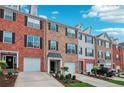 Attractive townhouses show a mix of brick and siding exteriors, with attached garages and neatly maintained landscaping at 3846 Chattahoochee Summit Se Dr # 31, Atlanta, GA 30339