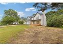 Side view of a two-story house with a covered front porch and well-maintained lawn at 470 Brackin Trce, Grayson, GA 30017