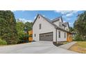 Two-story home with an attached garage and a private outdoor deck, surrounded by trees at 470 Brackin Trce, Grayson, GA 30017