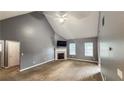 Spacious living room with vaulted ceiling, fireplace, and neutral carpet, ready for relaxation at 4005 Brushymill Ct, Loganville, GA 30052