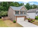 Well-maintained two-story home with neutral siding, a two-car garage, and landscaping at 4120 Cordova Ln, Cumming, GA 30028