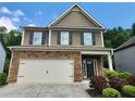 Beautiful two-story home with a stone-accented front, two-car garage, and nicely manicured landscaping at 4120 Cordova Ln, Cumming, GA 30028