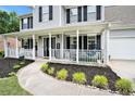 Inviting front porch featuring a white railing, black shutters and a manicured front lawn at 10 Callaway Ct, Hiram, GA 30141