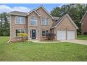 Charming two-story brick home with a well-manicured lawn and an attached two-car garage at 1024 Odelle Cir, Mcdonough, GA 30253