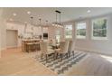 Open floor plan shows kitchen and dining room with many windows to let in natural light at 133 Prescott Manor Dr, Canton, GA 30115