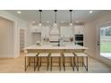 Bright kitchen with a large island, white cabinetry, stainless steel appliances and room for seating at 133 Prescott Manor Dr, Canton, GA 30115