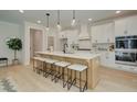 Stylish kitchen featuring a large center island, white cabinetry, and stainless steel appliances at 133 Prescott Manor Dr, Canton, GA 30115