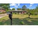 Quaint brick home with mailbox in front yard, mature trees, and an expansive lawn at 2365 Fontaine Cir, Decatur, GA 30032