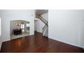 Bright entryway with gleaming hardwood floors, high ceilings, and a staircase at 2405 Brisbane Dr, Conyers, GA 30013