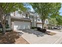 A view of the townhome complex with private driveways and mature trees at 441 Mountain View Ln, Woodstock, GA 30188