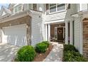 Inviting townhome entrance with brick accents and manicured landscaping at 441 Mountain View Ln, Woodstock, GA 30188