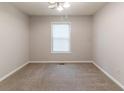 Comfortable bedroom featuring neutral paint, plush carpet, and ample natural light at 1045 Summer Hill Nw Ct, Acworth, GA 30102