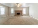 Spacious living room featuring a cozy stone fireplace and lots of natural light at 1045 Summer Hill Nw Ct, Acworth, GA 30102