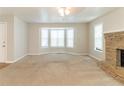 Inviting living room with large bay windows and stone fireplace at 1045 Summer Hill Nw Ct, Acworth, GA 30102