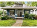 Charming blue house with a covered porch, swing, and colorful landscaping at 120 Warren Ne St, Atlanta, GA 30317