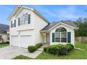 Charming two-story home featuring a two-car garage and neatly manicured lawn at 2722 South Hills, Riverdale, GA 30296