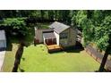 Aerial view of a well-maintained home, deck, and large yard with mature trees at 2926 Swarthmore Dr, Lawrenceville, GA 30044
