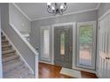 Inviting foyer with wood floors, staircase, and ample natural light at 2926 Swarthmore Dr, Lawrenceville, GA 30044