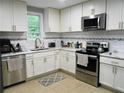 Well-lit kitchen featuring stainless steel appliances and modern white cabinetry at 2926 Swarthmore Dr, Lawrenceville, GA 30044
