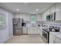 Bright kitchen features stainless steel appliances, white cabinets and tiled backsplash at 2926 Swarthmore Dr, Lawrenceville, GA 30044